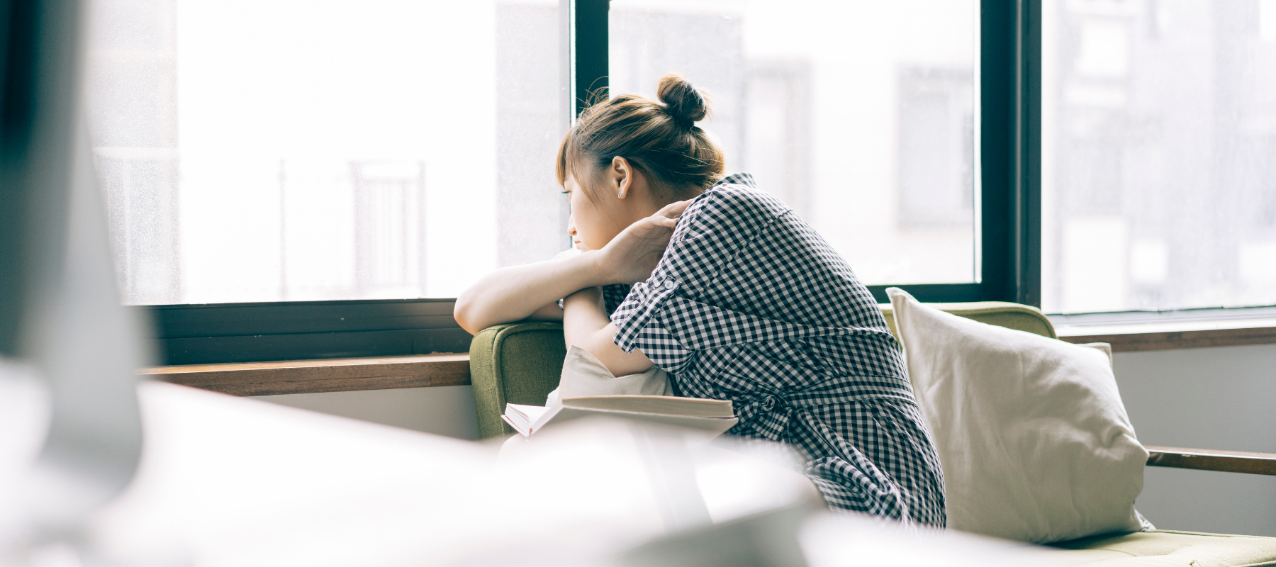 woman starting out of window while quarantining