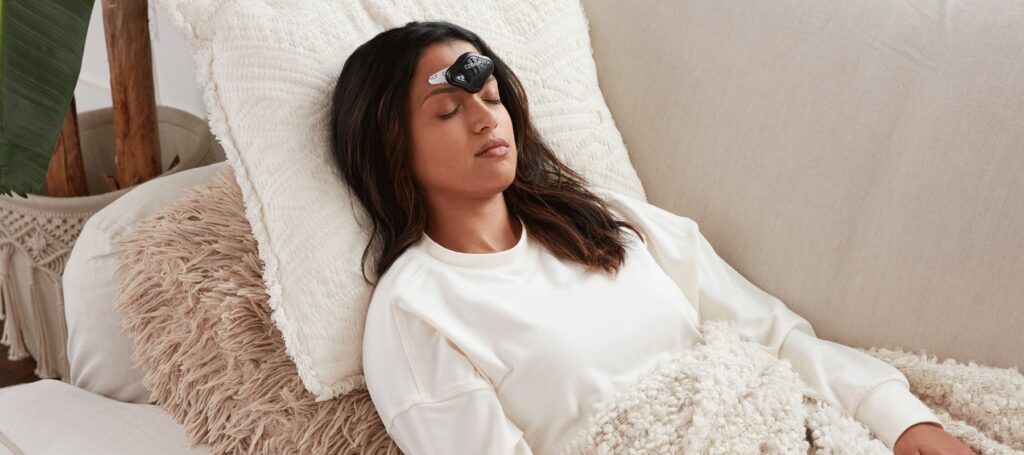 women laying down with cefaly connected device on